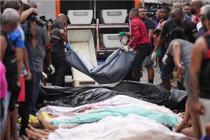 29.10.2025, Brasilien, Rio de Janeiro: Gerichtsmediziner sammeln die Leichen von Menschen ein, die am Vortag bei einer Polizeirazzia gegen die Bande Comando Vermelho in der Favela Complexo da Penha getötet wurden. 
