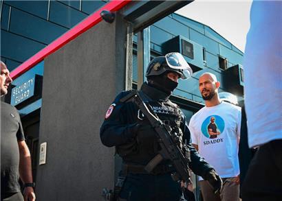 Andrew Tate wird nach einer Polizeirazzia in seinem Haus am Stadtrand von Bukarest zum Verhör geführt
