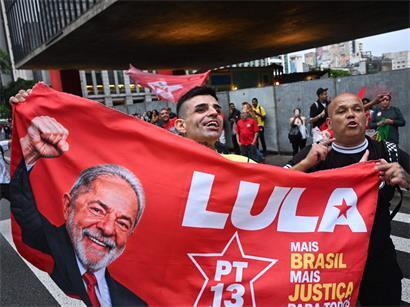 Anhänger des brasilianischen Präsidenten und Präsidentschaftskandidaten der Arbeiterpartei (PT), Luiz Inácio Lula da Silva, halten während der Stichwahl um das Präsidentenamt ein Transparent mit einem Bild von Lula hoch