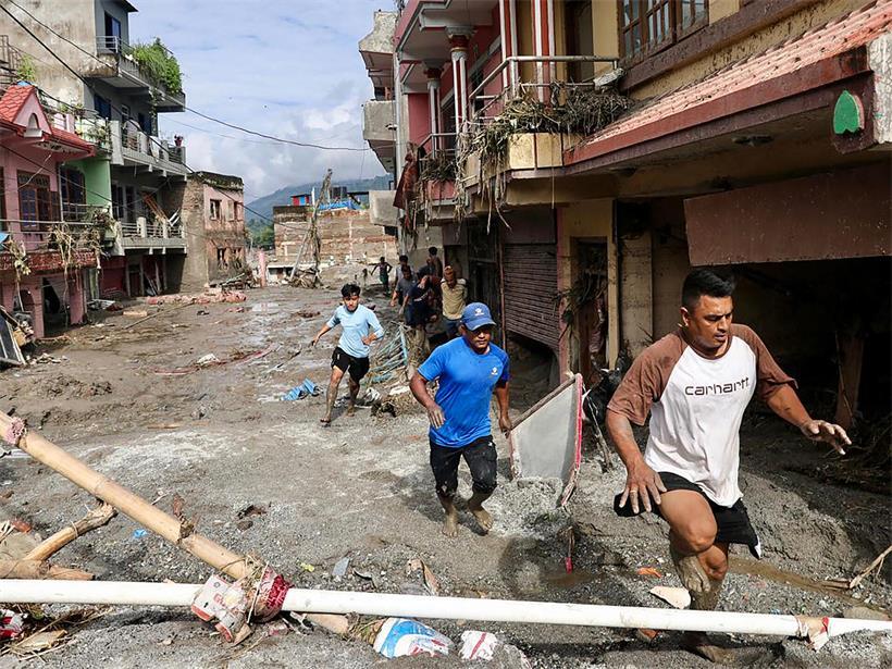 Mehr als 1.300 Vermisste – Bislang keine Luxemburger unter den Opfern Anwohner gehen am 27. August 2026 in Devighat, Gemeinde Bidur, im nepalesischen Distrikt Nuwakot an Häusern vorbei, die nach Sturzfluten unter Schlamm begraben sind