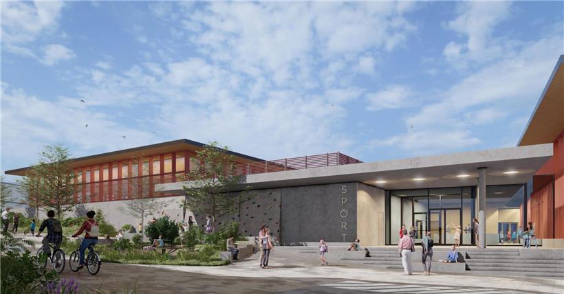 Sportkomplex mit moderner Architektur und Shared Space für Fußgänger und Radfahrer bei klarem Himmel