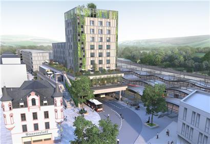 Blick auf die geplante Jugendherberge und das benachbarte Verwaltungsgebäude. Das Projekt wird über dem Busbahnhof und der dort unterirdisch verlaufenden Nationalstraße 7 errichtet.
