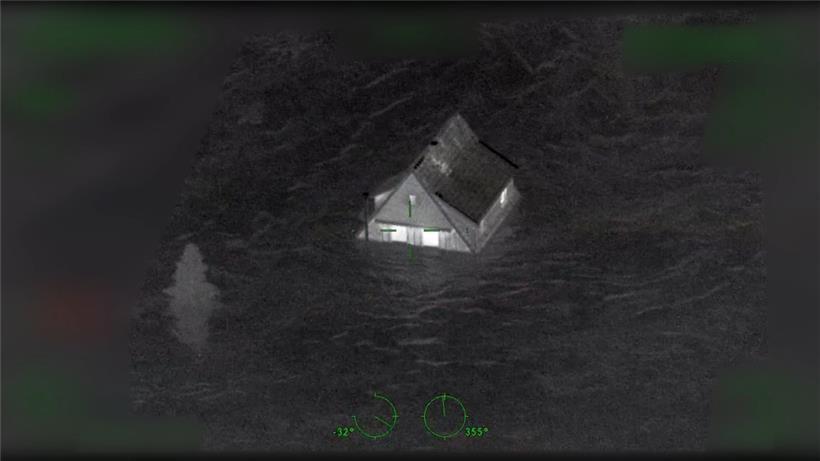 Das Standbild aus einem Video zeigt ein Haus, das von Wasser eingeschlossen ist. Die Videos wurden von einem Polizeihubschrauber in der Flutnacht im Ahrtal gemacht. 
