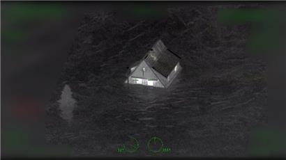 Das Standbild aus einem Video zeigt ein Haus, das von Wasser eingeschlossen ist. Die Videos wurden von einem Polizeihubschrauber in der Flutnacht im Ahrtal gemacht. 
