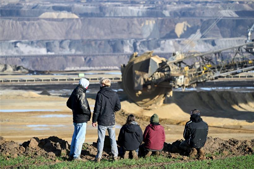 Demonstranten stehen an der Kante des Braunkohlentagebaus Garzweiler II