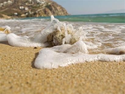 Strand bei Elias auf Mykonos, Griechenland, mit klarem Mittelmeerwasser und feinem Sand unter blauem Himmel