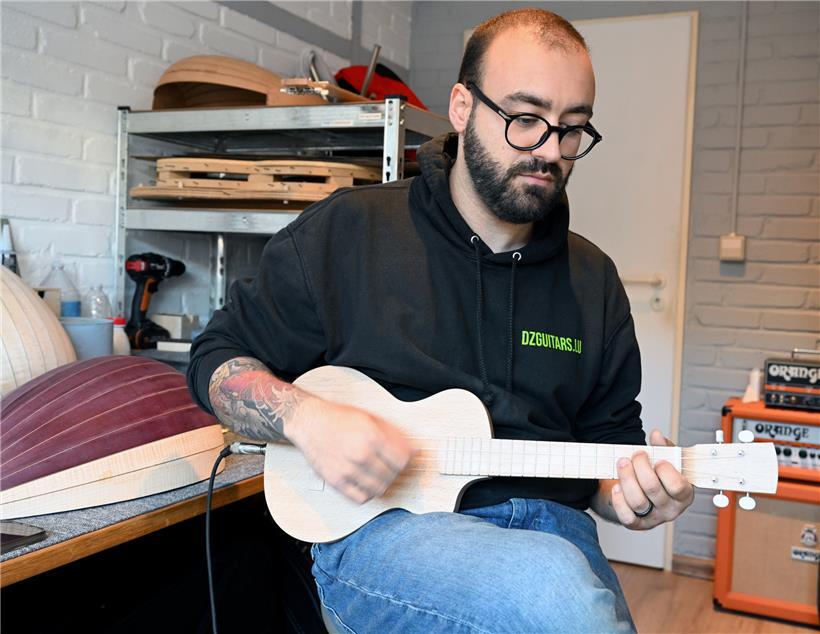 Der „luthier“ mit einer selbstgebauten elektrischen Ukulele
