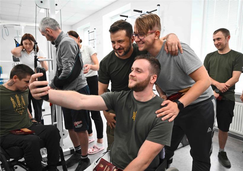 Der ukrainische Präsident Wolodymyr Selenskyj während eines Besuchs bei ukrainischen Kriegsversehrten in einem Rehabilitationszentrum 
