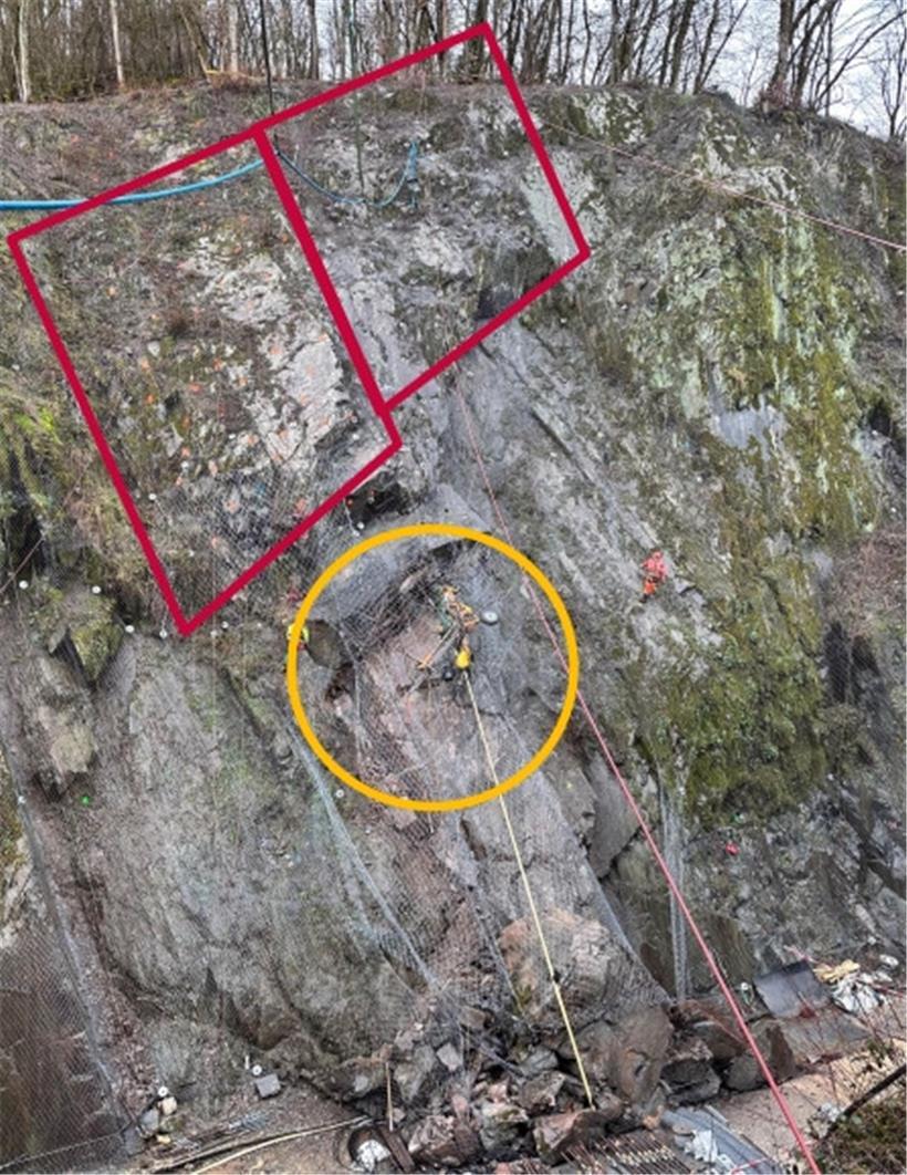 Die Felswand bei Bürden soll mittels passiver Verankerungen und diverser Netze (in Rot) gesichert werden. Brocken innerhalb des gelben Kreises haben sich am Wochenende gelöst.
