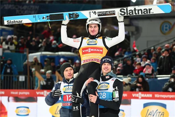  Domen Prevc (M, Slowenien) feiert mit Rok Oblak (Slowenien) und Anze Lanisek (l, Slowenien) nach seinem Sprung
