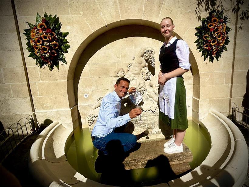Ehrengast Max Hahn durfte den Wein aus dem Wunderbrunnen ausschenken