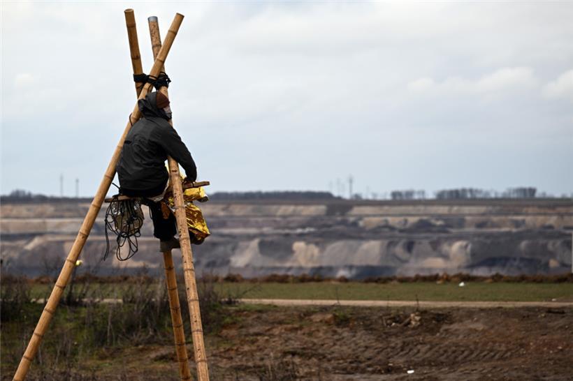 Ein Aktivist sitzt auf einem sogenannten Tripod in der Ortschaft Lützerath