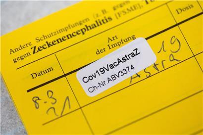 Ein Aufkleber mit der Aufschrift "Cov19VacAstraZ" klebt nach einer Impfung mit dem Impfstoff von AstraZeneca in einem Impfausweis im Impfzentrum in der Koelnmesse
