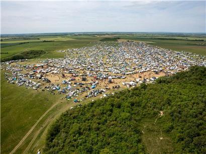 Luftaufnahme der großen Teilnehmermenge einer Teknival-Rave-Party auf dem Militärgelände in Cornusse bei Bourges