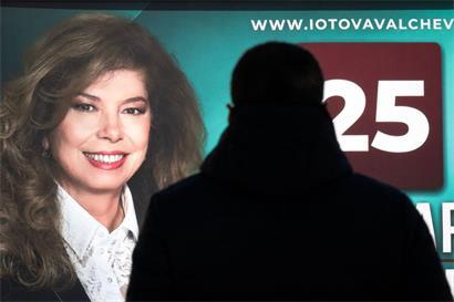 Ein Mann steht vor einem Wahlplakat für die Präsidentschaftswahlen der Amtsinhaberin Ilijana Jotowa in Sofia 