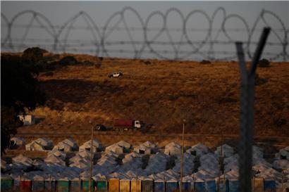 Ein Polizeiauto patrouilliert oberhalb eines provisorischen Zeltlagers für geflüchtete Menschen auf Lesbos: Der Abschluss des Flüchtlingsabkommens zwischen der EU und der Türkei liegt fünf Jahre zurück – die europäische Migrationspolitik seitdem ist gescheitert
