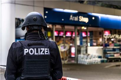 Ein Polizist sichert am frühen Morgen eine Tankstelle. Ein Angestellter der Tankstelle war in Idar-Oberstein in Rheinland-Pfalz von einem mit einer Pistole bewaffneten Mann erschossen worden. 
