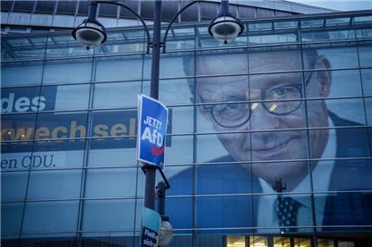 Ein riesiges Wahlplakat mit dem Konterfei von Friedrich Merz, CDU Bundesvorsitzender und CDUCSU Fraktionsvorsitzender im Bundestag, ist an der CDU-Parteizentrale hinter einem Wahlplakat der AfD zu sehen. Im Bundestag wird über ein «Zustrombegrenzungsgesetz» der Unionsparteien entschieden.

