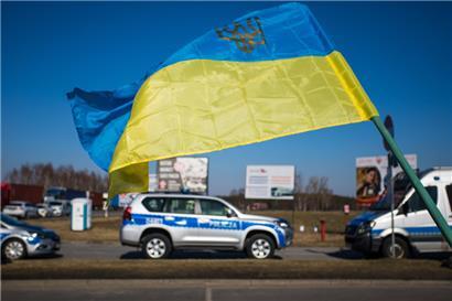 Eine ukrainische Fahne weht bei Protesten an der polnisch-belarussischen Grenze 
