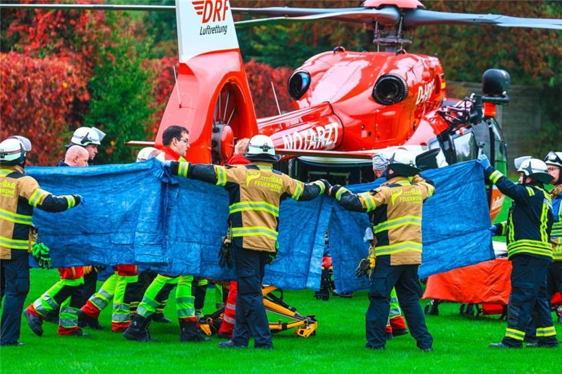 Einsatzkräfte stehen neben einem Rettungshubschrauber. Die neu gewählte Bürgermeisterin von Herdecke, Iris Stalzer, ist lebensgefährlich verletzt in ihrer Wohnung gefunden worden

