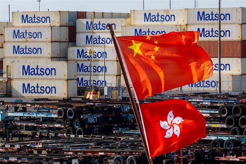 Flaggen, die China und Hongkong repräsentieren, wehen von einem Schiff im Hafen von Oakland
