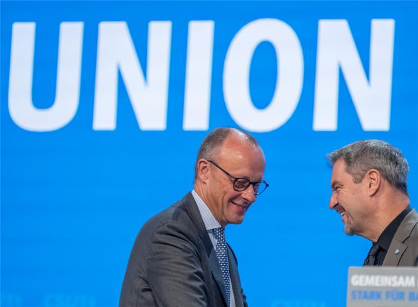 Friedrich Merz (l.), CDU-Bundesvorsitzender und Unionsfraktionsvorsitzender, und Markus Söder, Vorsitzender der CSU, stehen auf dem Parteitag der CSU zusammen auf der Bühne
