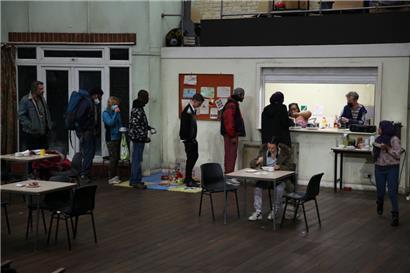 Hazel (Llewella Gideon) serves food for those in need in a run-down community centre
