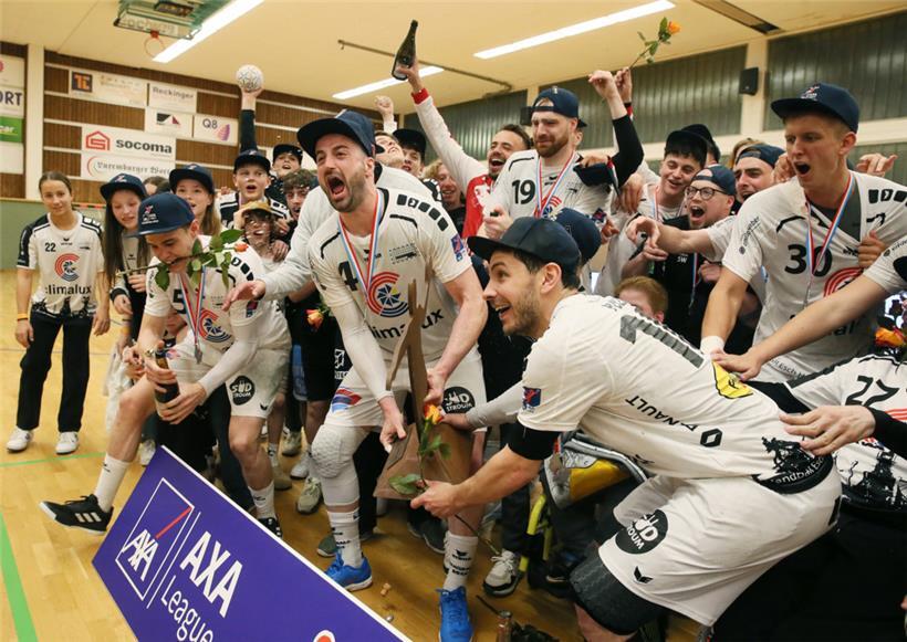 Martin Muller (Nummer 4) und Sacha Pulli, die beide ihre Handballkarrieren beenden, nehmen die Meistertrophäe entgegen
