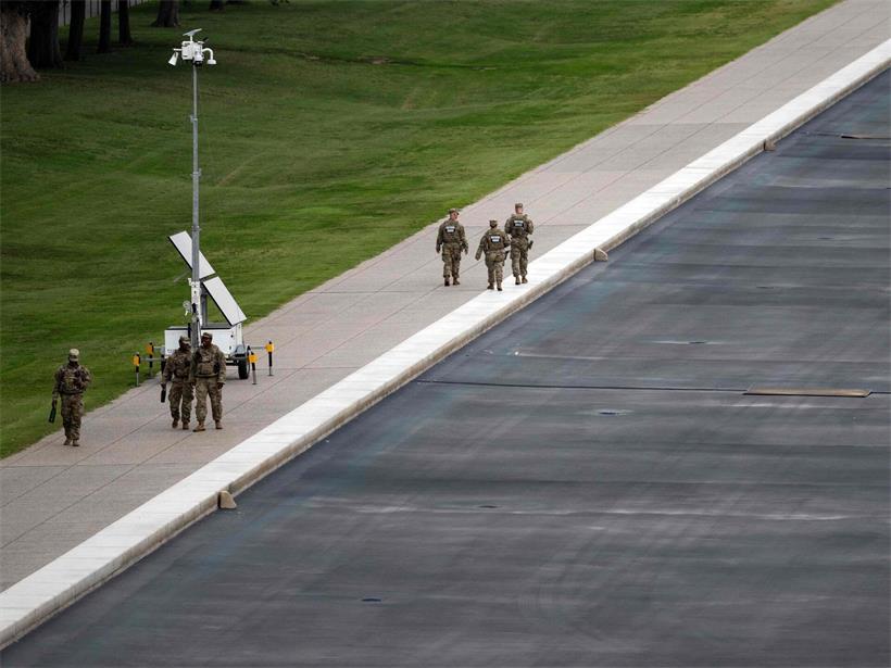Members of the National Guard walk along the drained Lincoln Memorial Reflecting Pool on the National Mall in Washington, DC on July 30, 2026. The renovation of the pool next to Lincoln Memorial is a pet project of US President Donald Trump’s, but the remodel has been dogged by the growth of algae and peeling paint which the president alleges is the work of vandals. (Photo by Kent Nishimura / AFP)