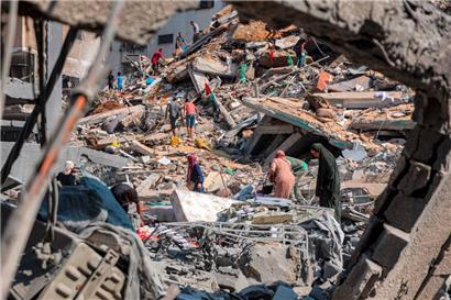 Menschen durchsuchen die Trümmer nach einem nächtlichen israelischen Bombardement des Gaza-Stadtteils Rimal
