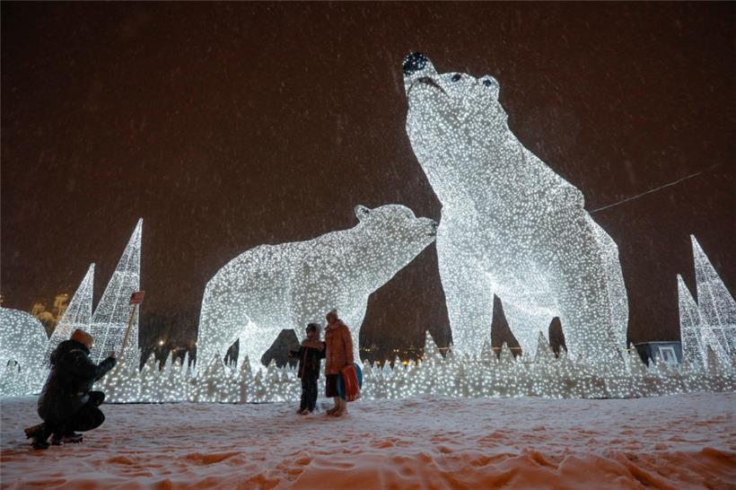  Menschen posieren in Moskau für Fotos vor der Neujahrsdekoration.
