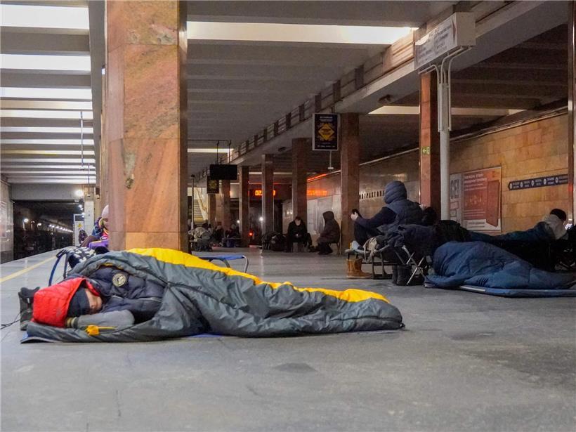 Menschen flüchten während russischem Luftangriff und suchen Schutz in einer belebten U-Bahn-Station.