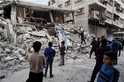 Palästinenser schauen auf die Schäden nach einem Luftangriff der israelischen Armee in Gaza-Stadt
