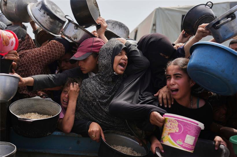 Palästinensische Kinder erhalten gespendete Lebensmittel in einem Verteilungszentrum in Chan Junis, Gazastreifen
