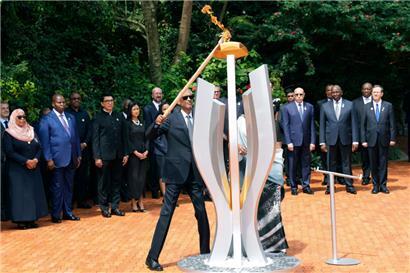 Paul Kagame (Mitte), Präsident von Ruanda, entzündet am 7. April eine Gedenkflamme während einer Zeremonie zum 30. Jahrestag des ruandischen Völkermords am Völkermorddenkmal
