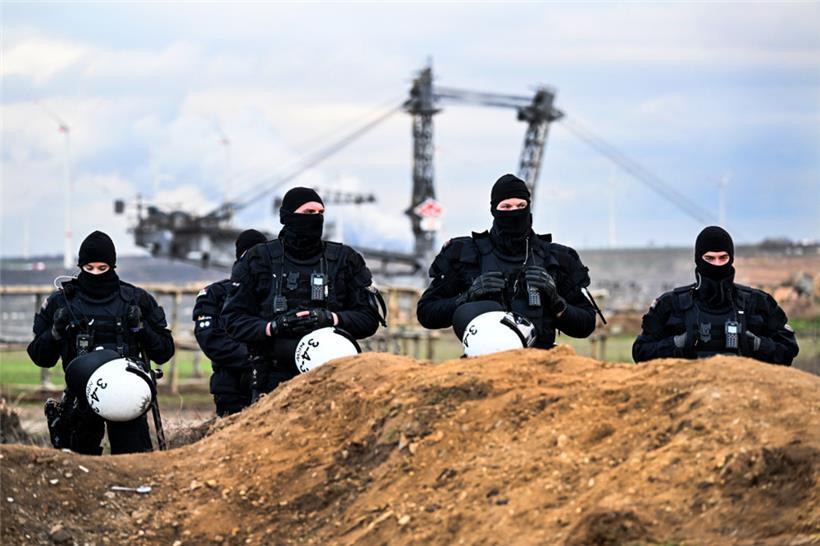 Polizisten sichern das Gelände beim Braunkohletagebau Garzweiler II