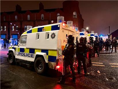 Polizisten stehen auf der Springfield Road in Belfast: In der britischen Provinz Nordirland kommt es seit Tagen zu nächtlichen Krawallen
