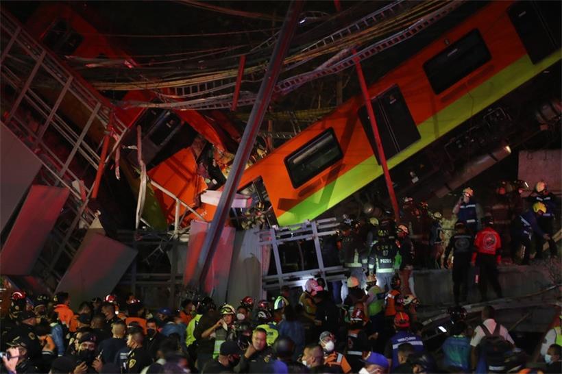 Rettungskräfte stehen am Unfallort, nachdem eine U-Bahn-Brücke zum Teil eingestürzt ist
