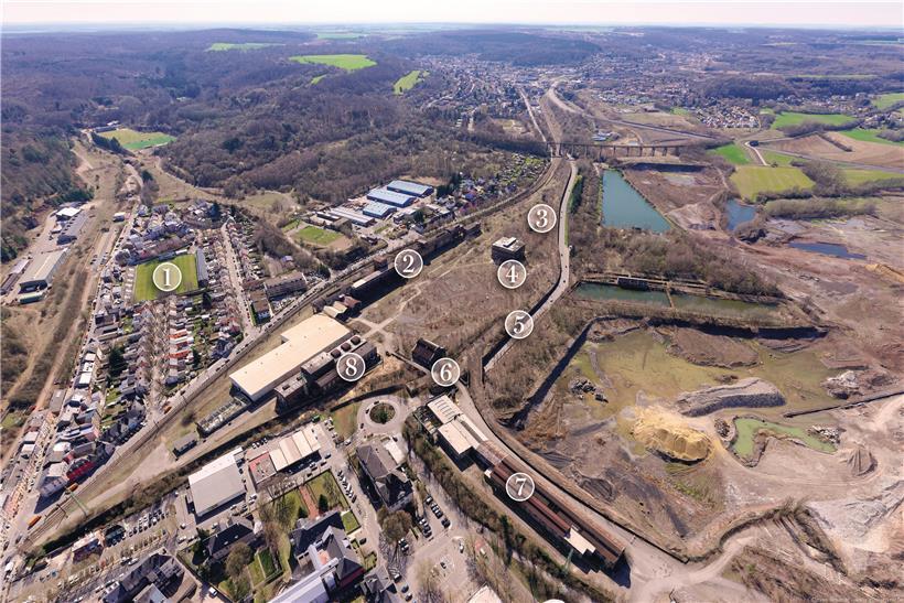  „Rout Lëns“ auf einen Blick: 1) Kleine Orientierungshilfe: der Jeunesse-Fußballplatz in der Hiel. 2) Die „Keeseminnen“, die abgesehen von den Portalen aus Stahl und laut aktueller Planung keinen Platz im neuen Projekt haben. 3) Das Stellwerk im Bauhausstil. 4) Die Gebläsehalle. 5) Die Schutz- und Stützmauer an der rue d’Audun. 6) Das ehemalige Ersatzteillager „Magasin…
