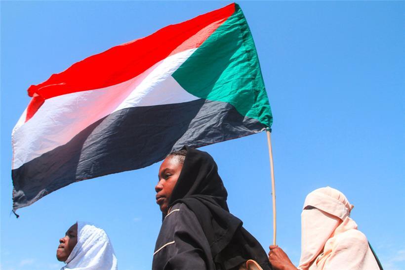 Sudanesische Schüler halten während einer Protestkundgebung gegen die Verstöße der Rapid Support Forces (RSF) gegen die Bevölkerung die sudanesische Flagge hoch
