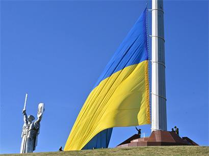 Ukrainische Soldaten hissen am 23. August 2026 in Kiew anlässlich einer Feier zum Tag der Nationalflagge der Ukraine die größte Nationalflagge des Landes an einem Fahnenmast vor dem Mutterland-Denkmal