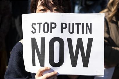 Weltweite Proteste: In Tokio fordert eine Frau, Wladimir Putin aufzuhalten.
