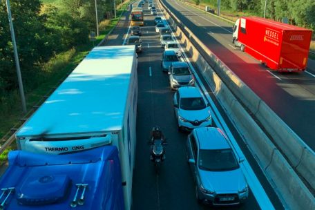 Ein Motorradfahrer schlängelt sich durch den Stau auf der A3