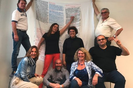 Claudio Cicotti (assis au centre) et les participants à un atelier d’écriture, autour d’un „drap“ autobiographique 
