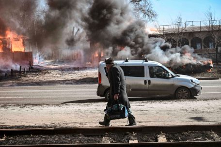 Ein Mann flieht mit einer Tasche in der Hand aus der Stadt Charkiw