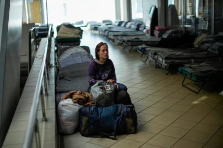 Ukraine, Dnipro: Iulia Shevchuk sitzt am 28. April auf einem Feldbett in einer Flüchtlingsunterkunft.