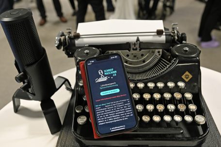 Technische Quantensprünge: Ein Smartphone, das auf einer alten Schreibmaschine liegt, zeigt das neue Programm für luxemburgische Spracherkennung an